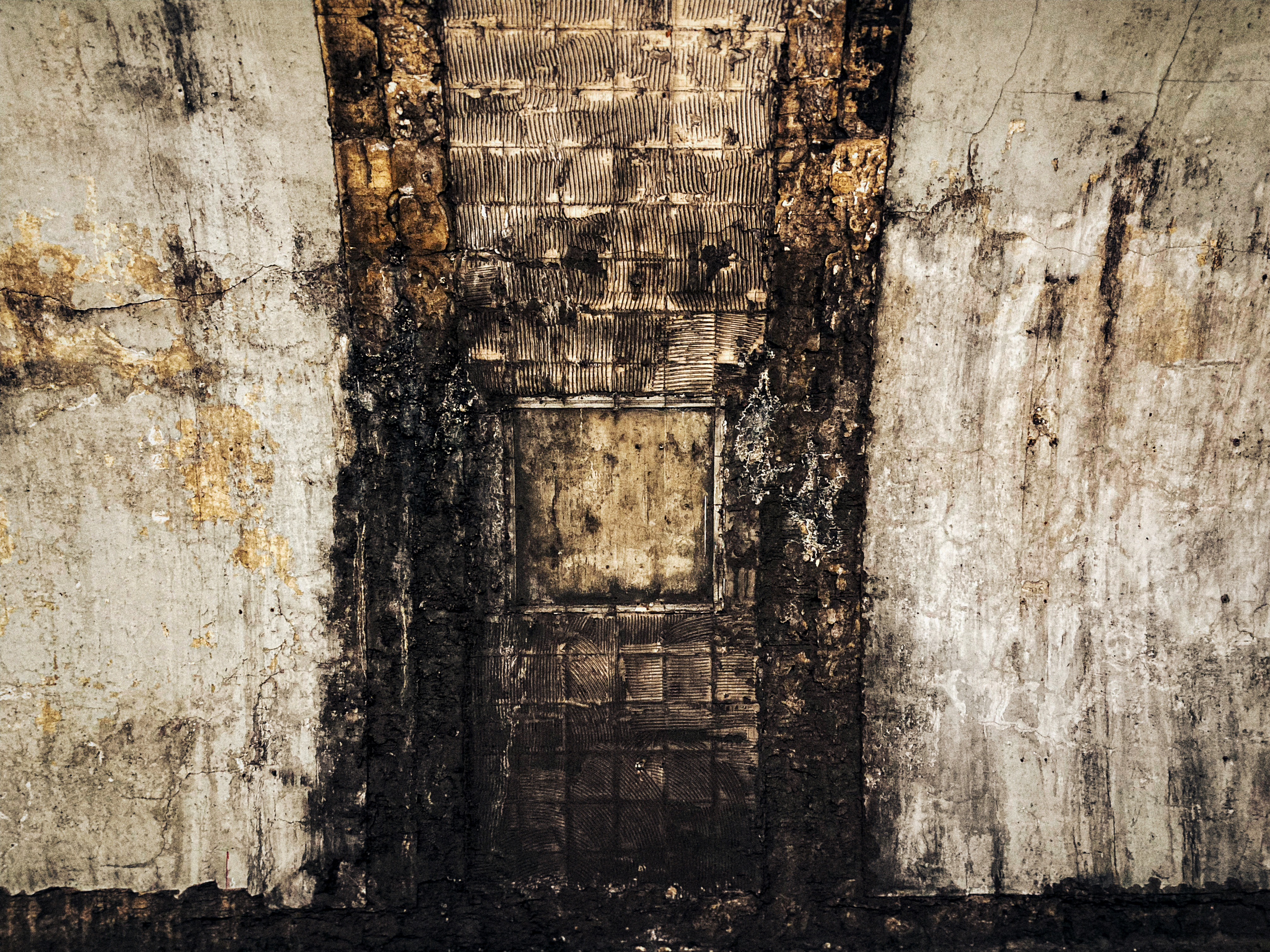 A textured photograph with intricate details and shadows, suggesting depth and complexity in underground spaces.